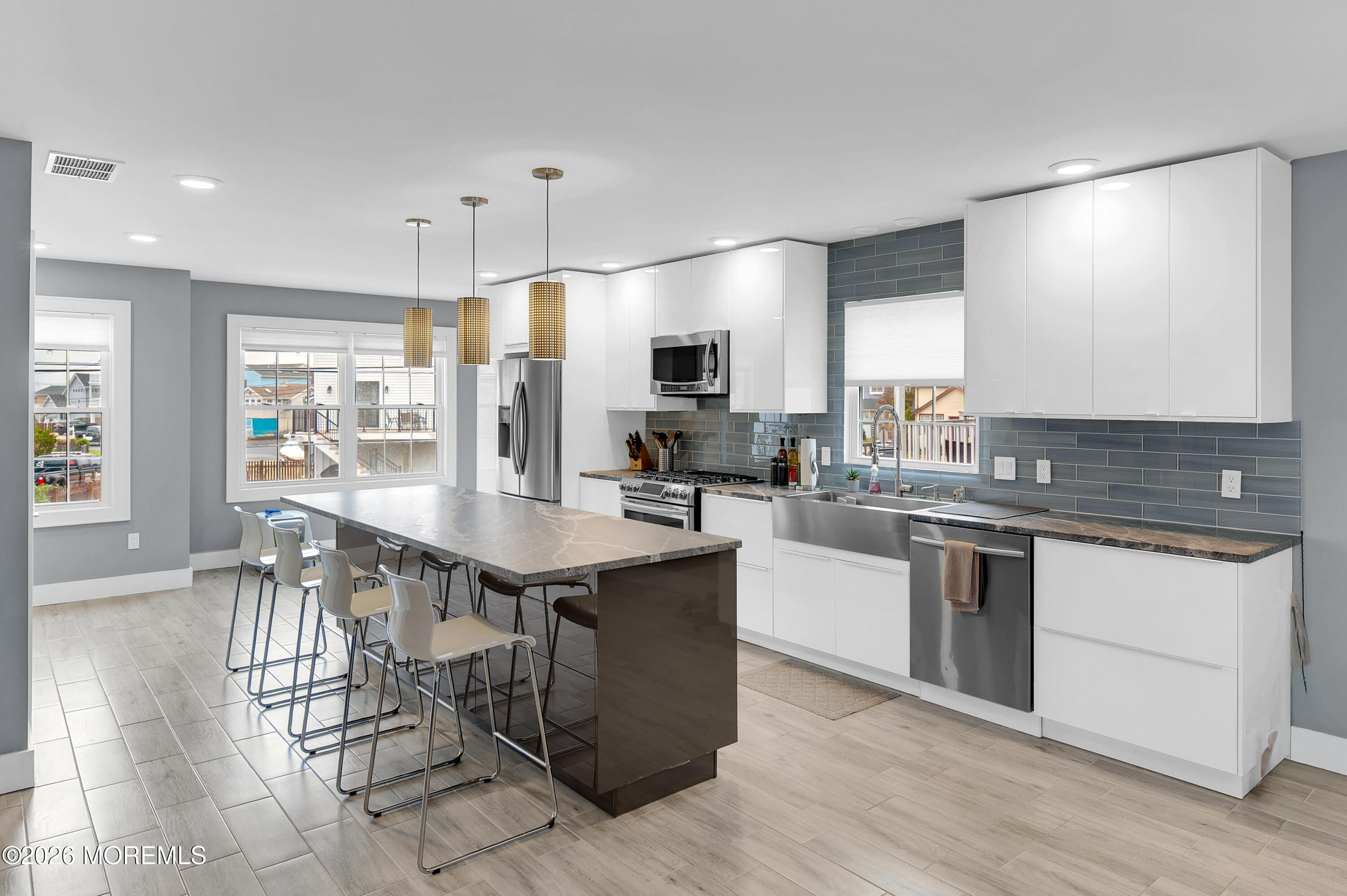 97 Bay View Drive Brick, NJ 08723 - Photo 12 of 65 a kitchen with granite countertop a table chairs stove a sink and dishwasher