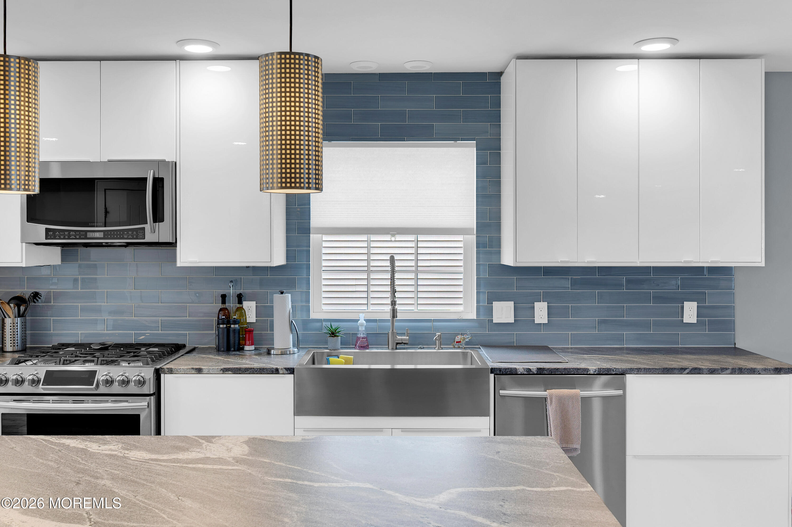 97 Bay View Drive Brick, NJ 08723 - Photo 14 of 65 a kitchen with kitchen island granite countertop a sink stainless steel appliances and cabinets