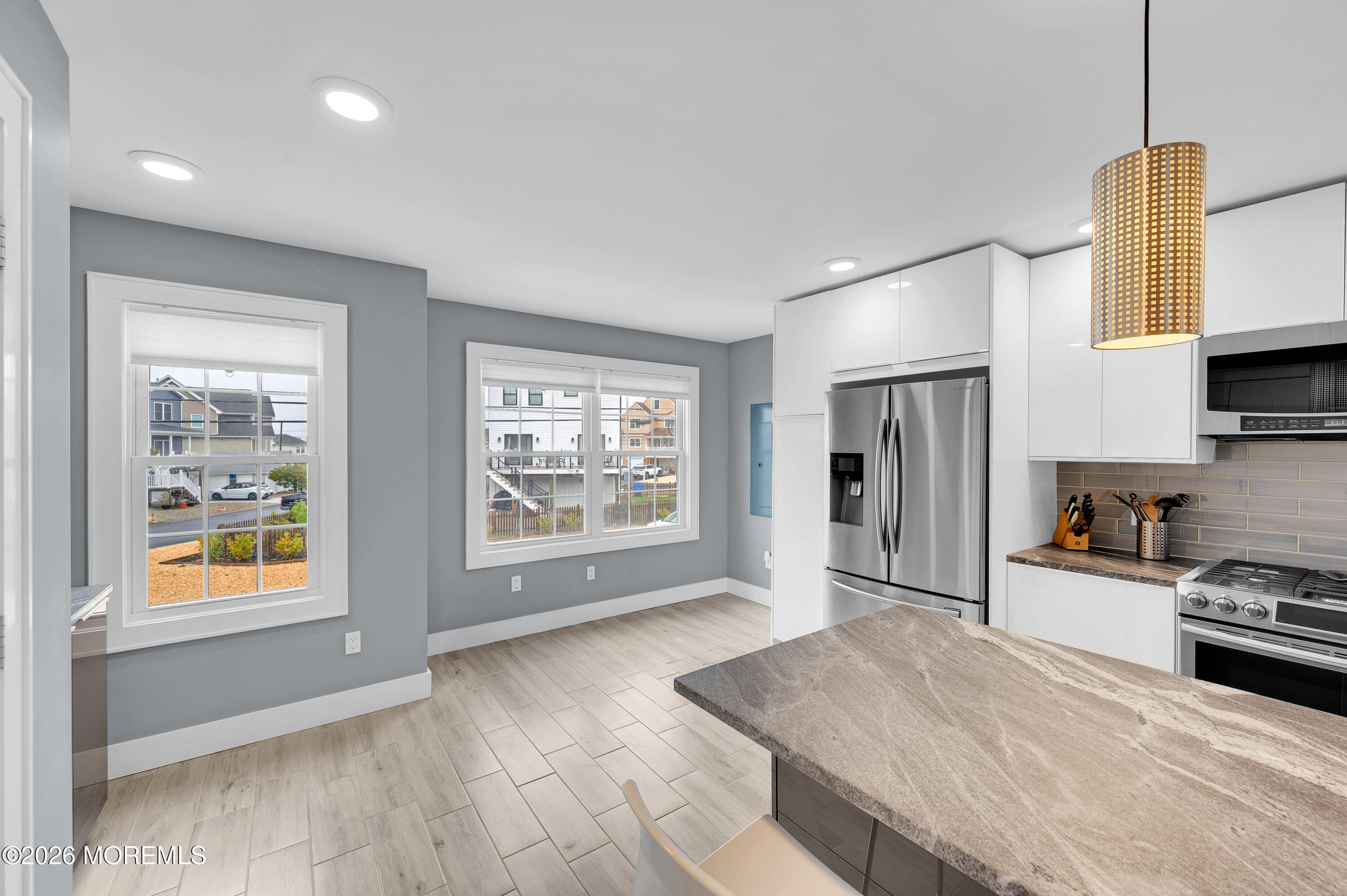 97 Bay View Drive Brick, NJ 08723 - Photo 15 of 65 a kitchen with stainless steel appliances granite countertop a stove a sink and a refrigerator with wooden floor