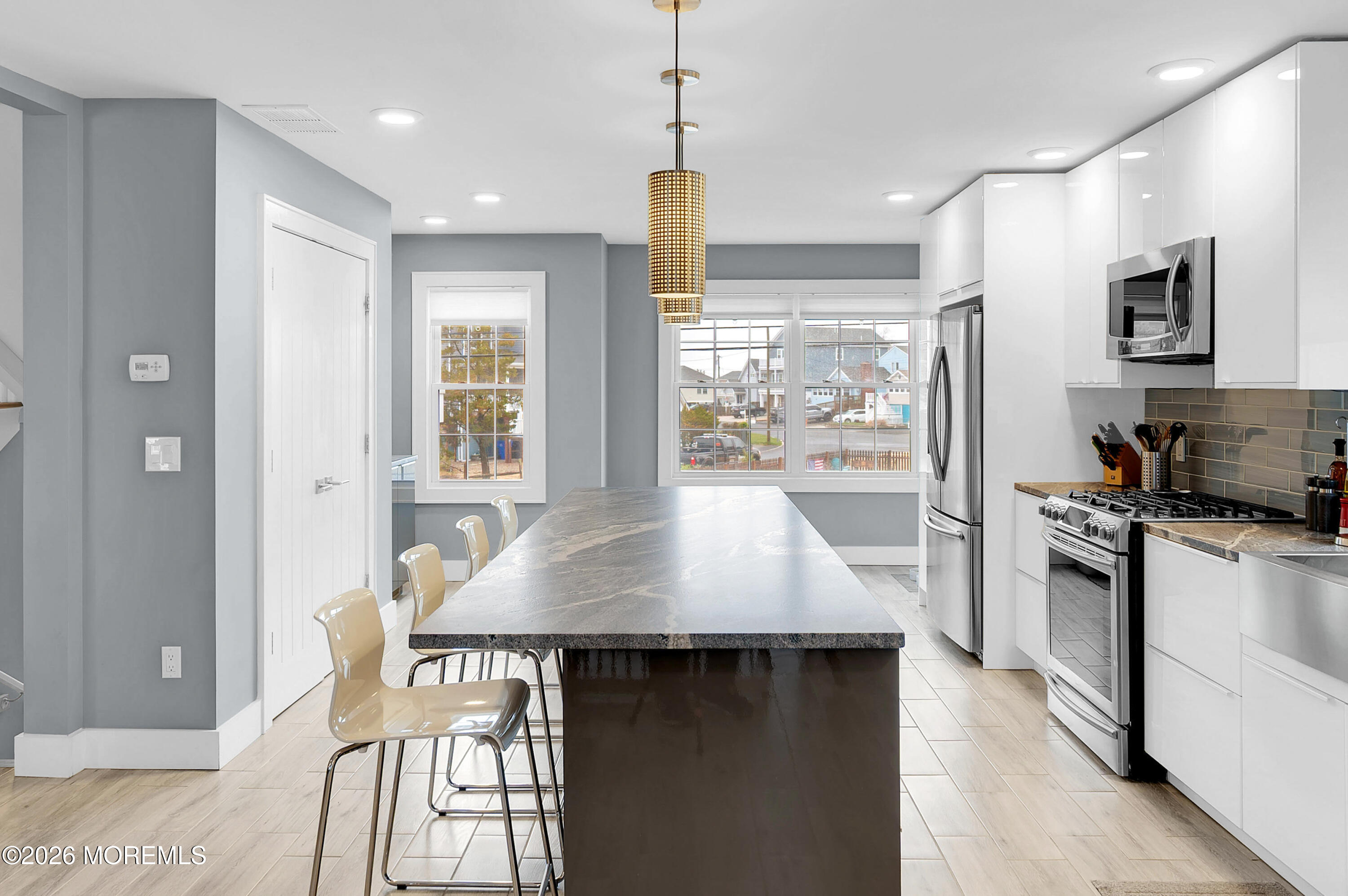 97 Bay View Drive Brick, NJ 08723 - Photo 19 of 65 a kitchen with a table chairs stove and refrigerator