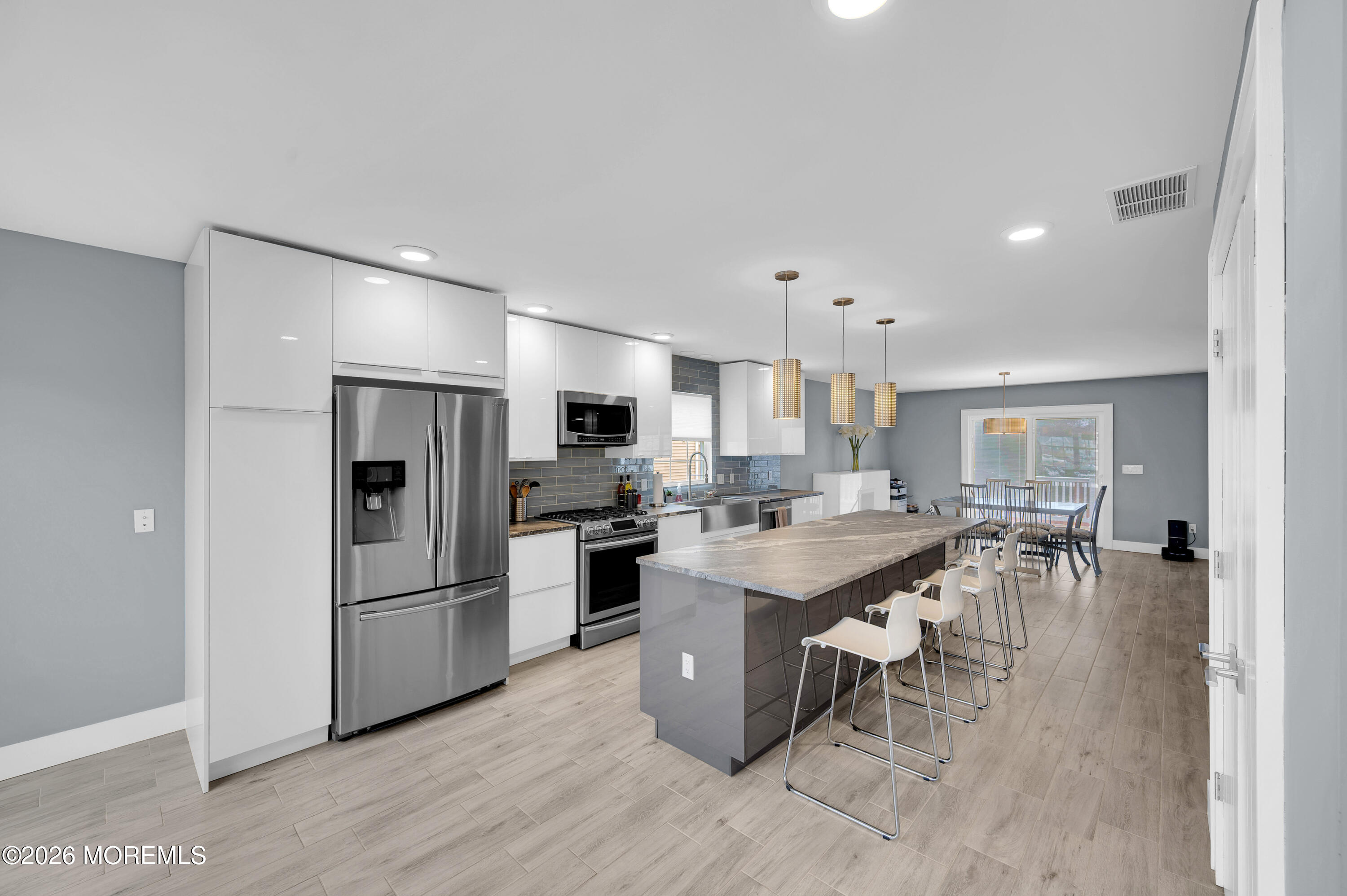 97 Bay View Drive Brick, NJ 08723 - Photo 23 of 65 a large kitchen with a table and chairs