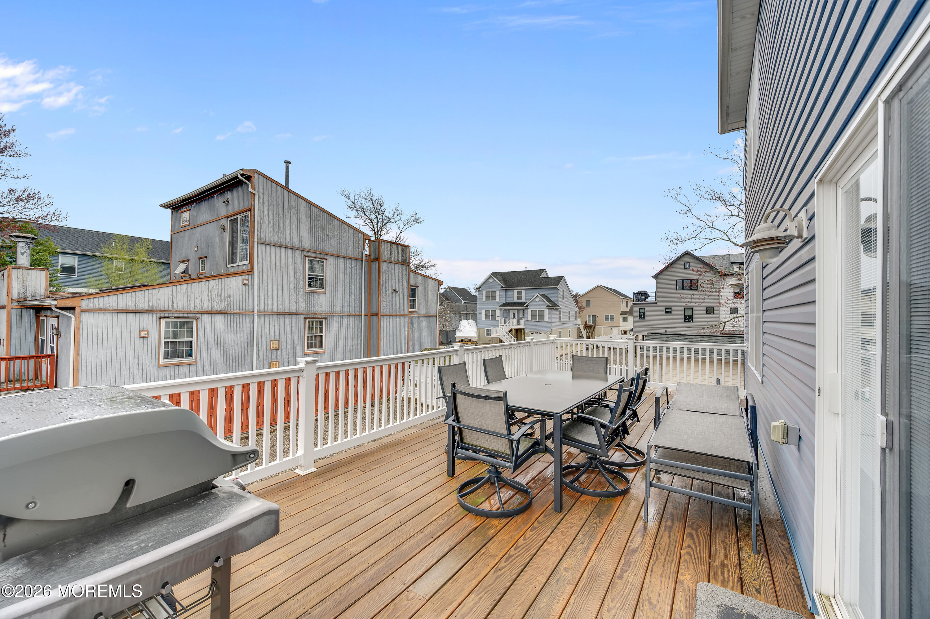 97 Bay View Drive Brick, NJ 08723 - Photo 43 of 65 a view of a roof deck with table and chairs and wooden floor