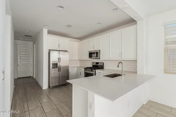a kitchen with stainless steel appliances a refrigerator sink and cabinets