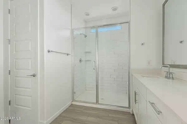 a bathroom with a shower and a sink