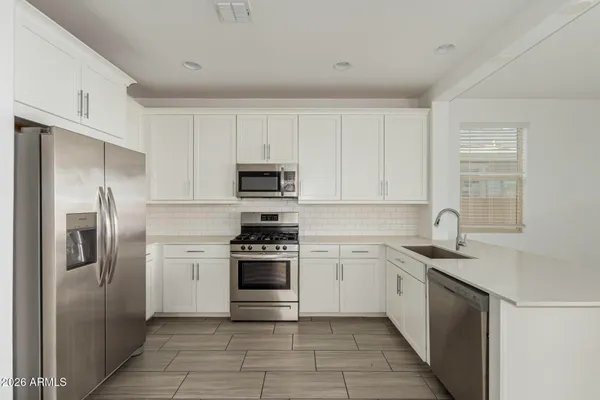 a kitchen with a sink appliances and cabinets