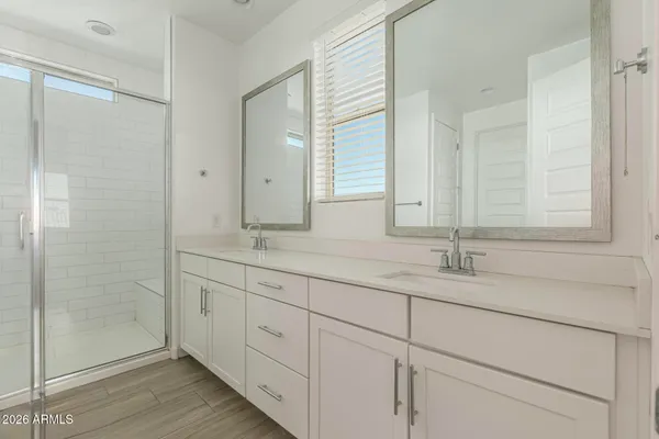 a bathroom with double sink and a mirror