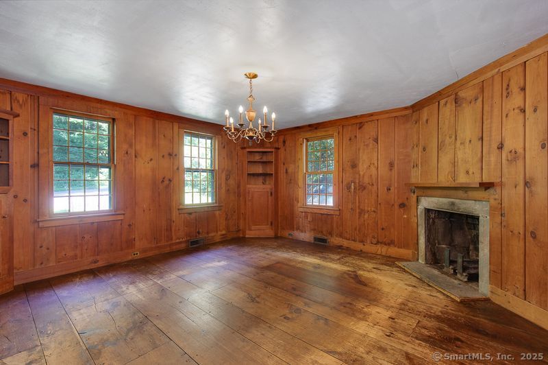208 Woodcreek Road Bethlehem, CT 06751 - Photo 9 of 29 a view of an empty room with exposed radiator and fireplace