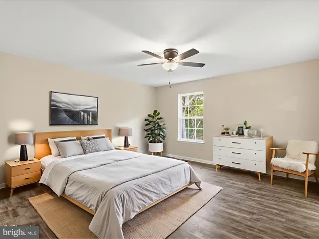 a bedroom with a large bed and a large window