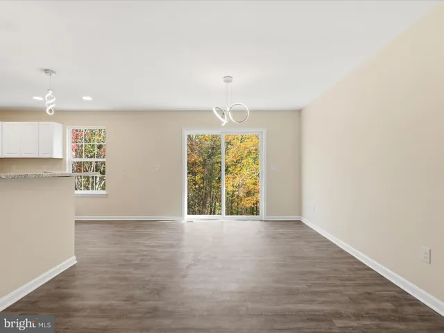 a kitchen with kitchen island granite countertop a refrigerator oven a sink and dishwasher
