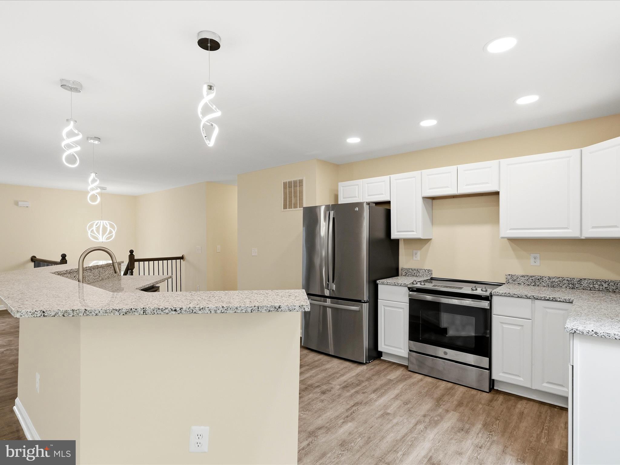 3281 Russel Run Road Locust Grove, VA 22508 - Photo 22 of 78 a kitchen with kitchen island granite countertop a refrigerator oven a sink and dishwasher