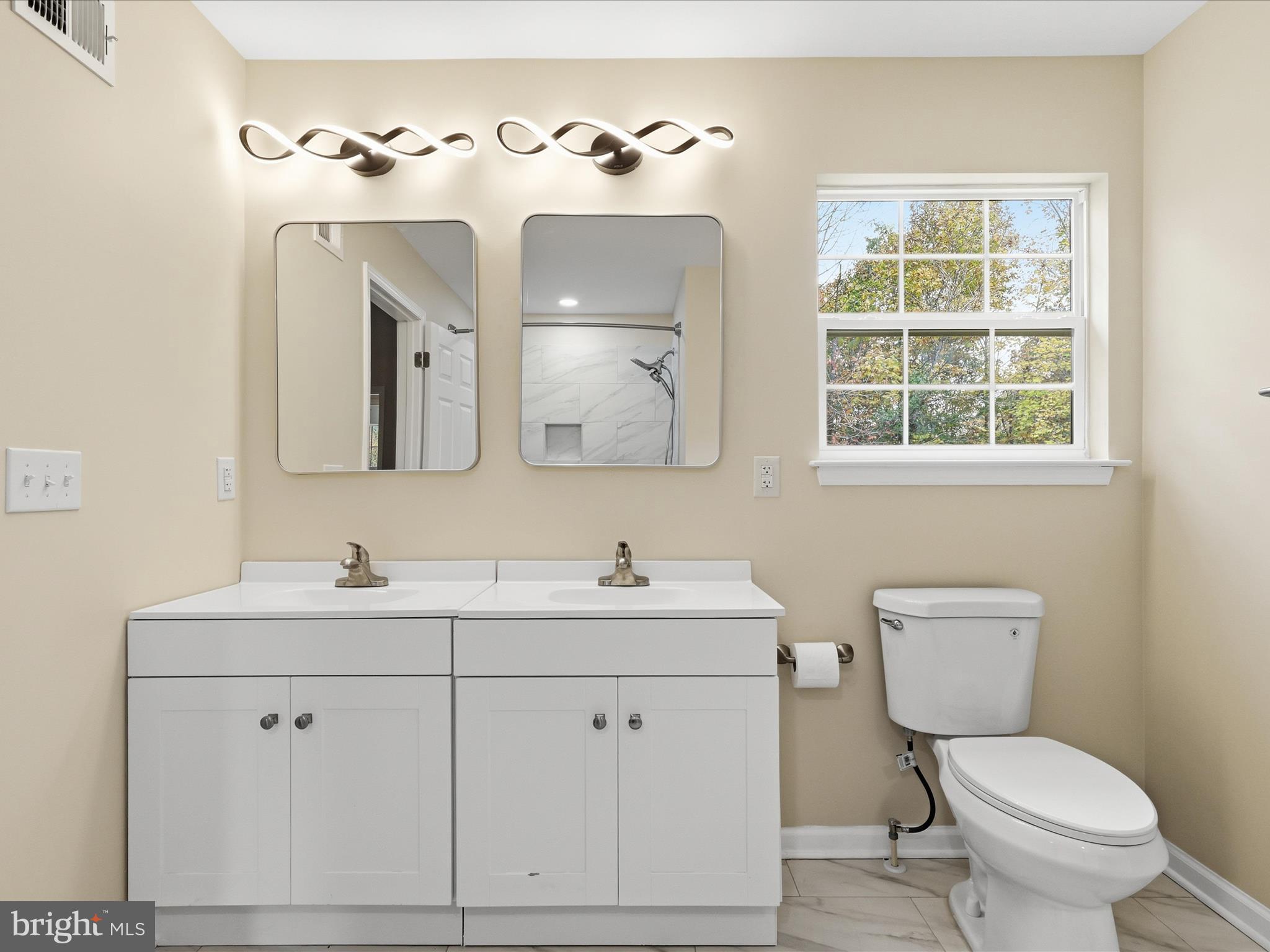 3281 Russel Run Road Locust Grove, VA 22508 - Photo 32 of 78 a bathroom with a toilet sink and mirror