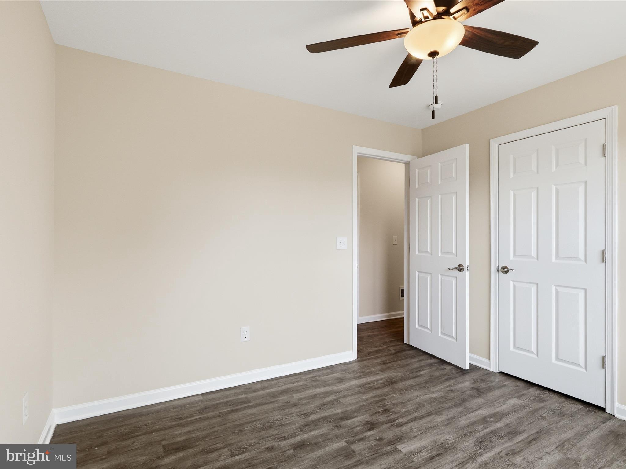 3281 Russel Run Road Locust Grove, VA 22508 - Photo 35 of 78 an empty room with wooden floor fan and windows
