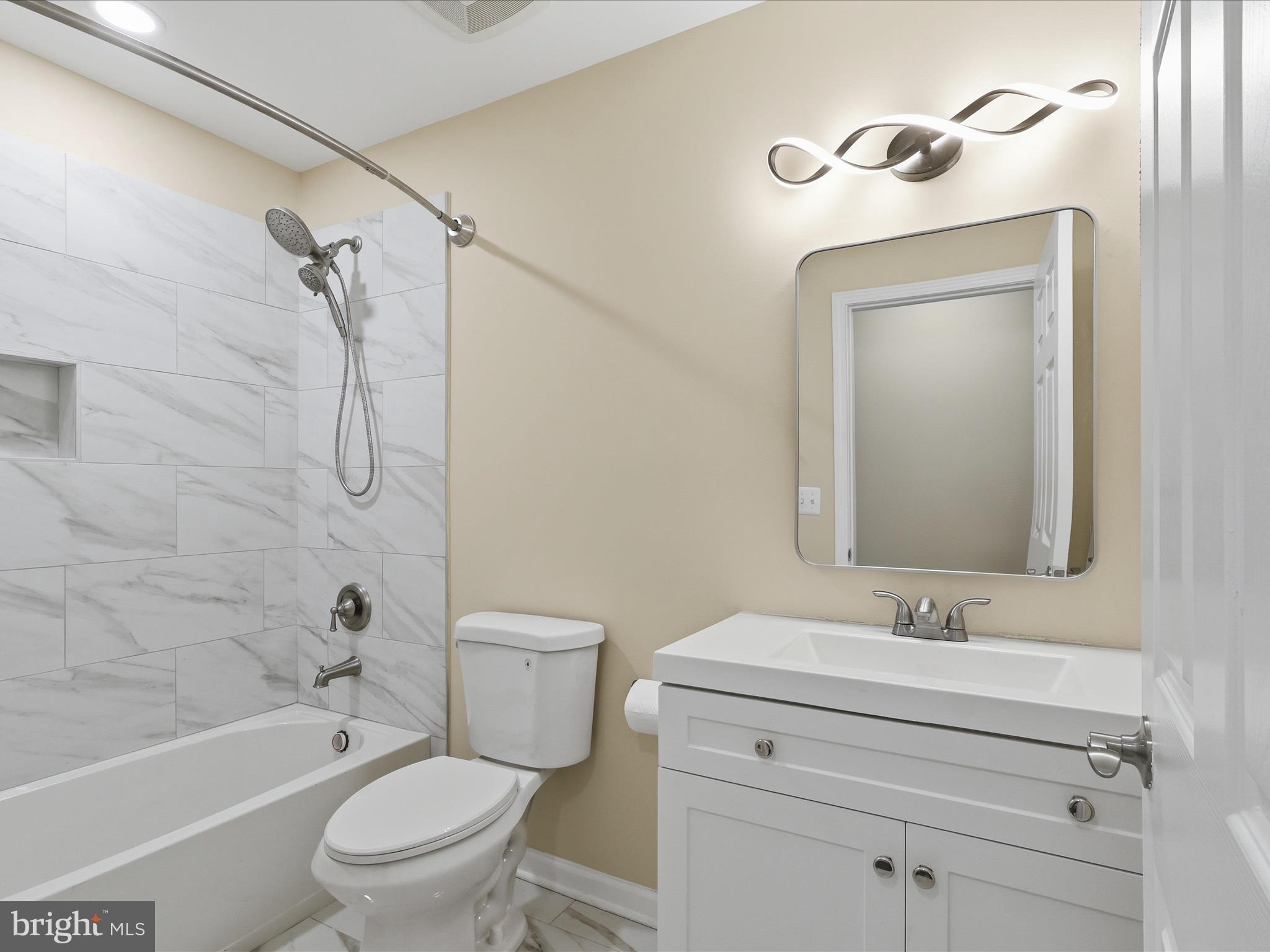 3281 Russel Run Road Locust Grove, VA 22508 - Photo 37 of 78 a bathroom with a granite countertop toilet a sink and a bathtub