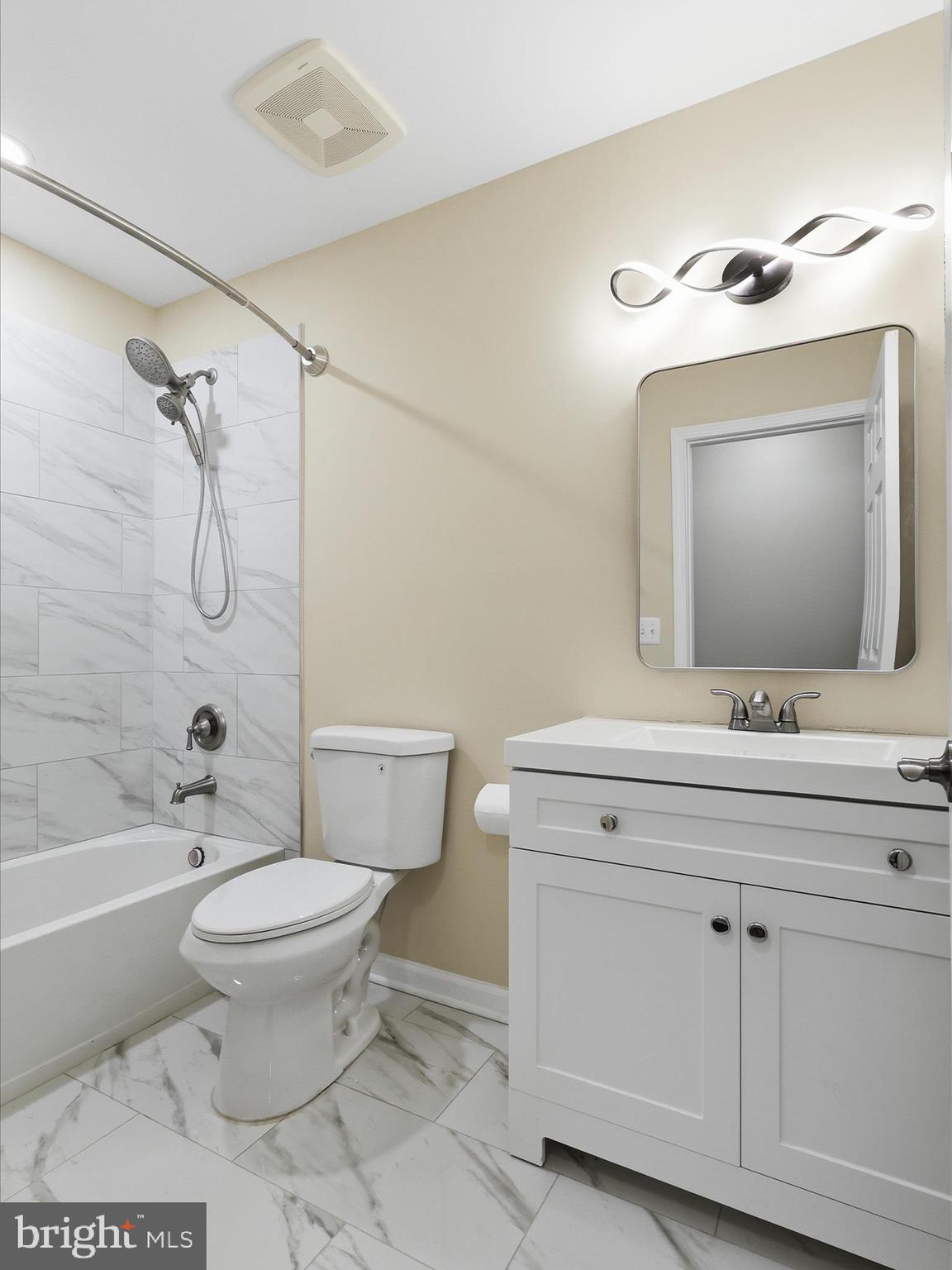 3281 Russel Run Road Locust Grove, VA 22508 - Photo 38 of 78 a bathroom with a toilet a sink a mirror a bathtub and vanity