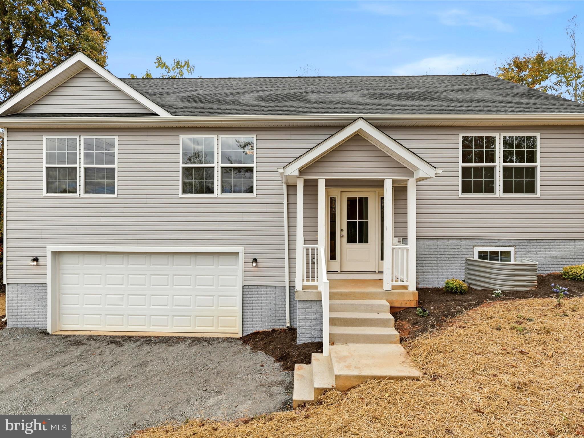 3281 Russel Run Road Locust Grove, VA 22508 - Photo 53 of 78 a front view of a house with a yard and garage