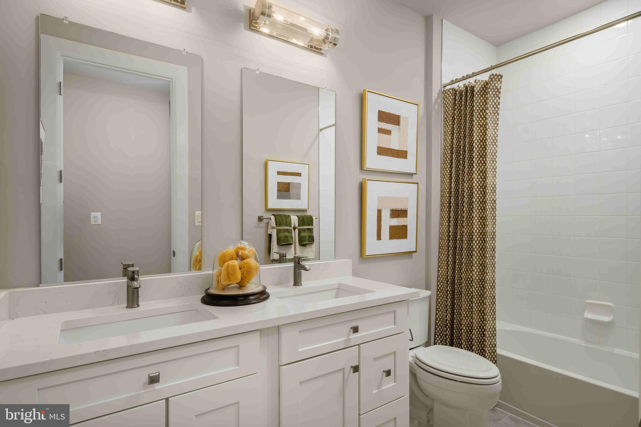5446 Pondview Lane Ellicott City, MD 21043 - Photo 13 of 21 a bathroom with a double vanity sink toilet and shower