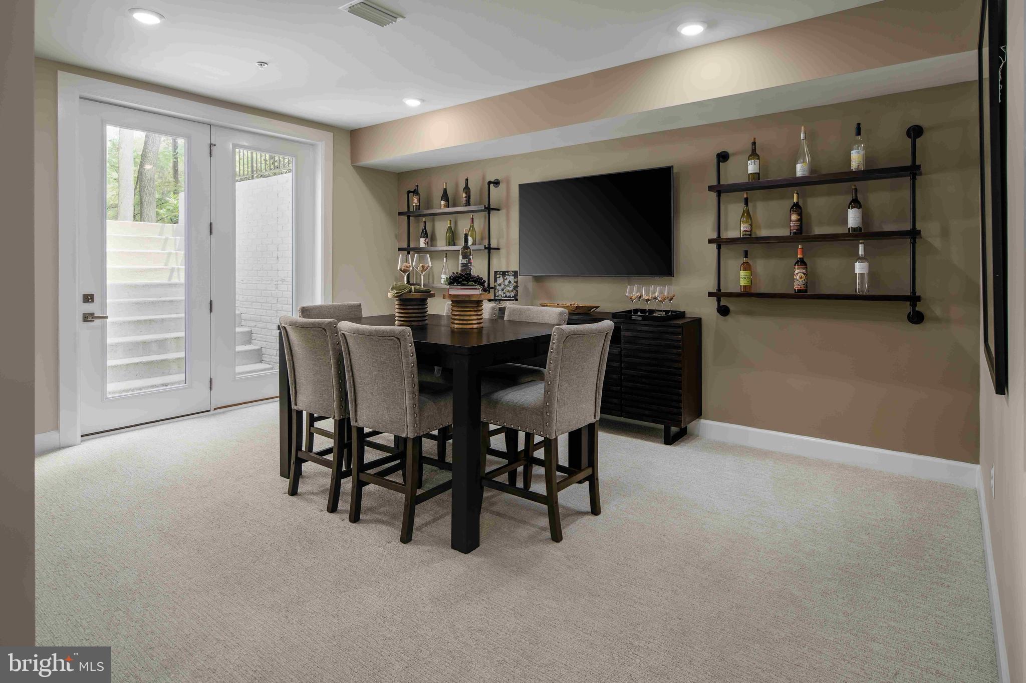 5446 Pondview Lane Ellicott City, MD 21043 - Photo 17 of 21 a view of a dining room with furniture and a flat screen tv