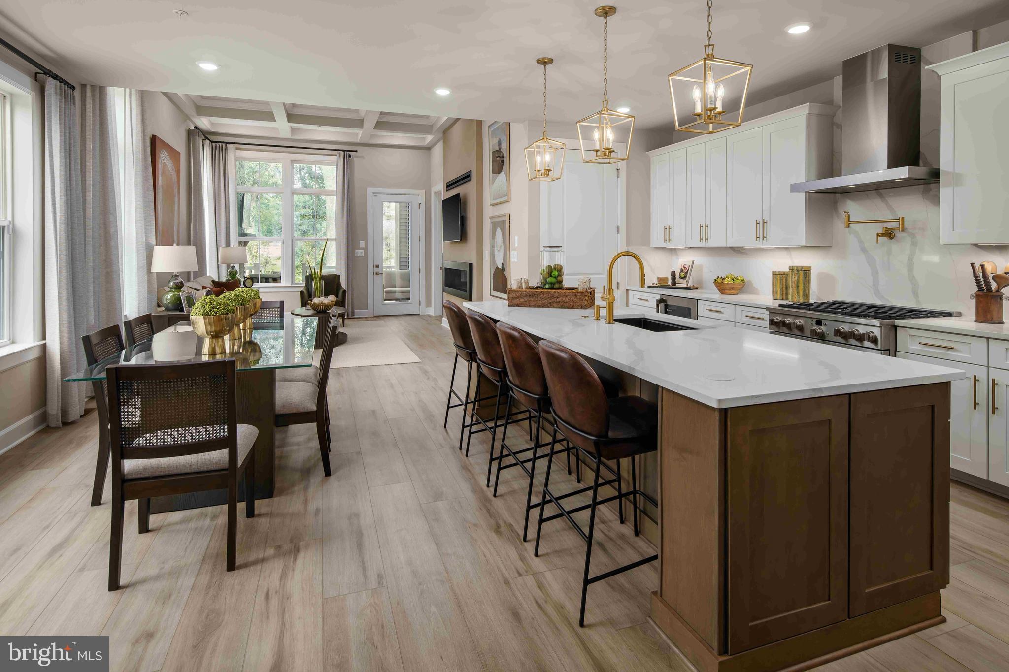 5446 Pondview Lane Ellicott City, MD 21043 - Photo 4 of 21 a kitchen with stainless steel appliances granite countertop a stove a refrigerator a kitchen island a dining table and chairs with wooden floor