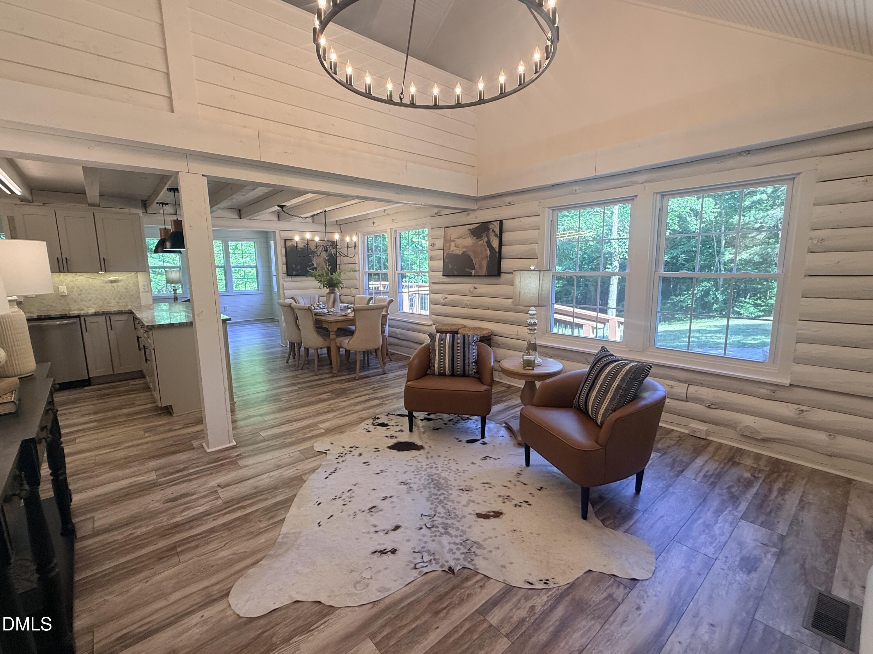 327 Shady Oak Road Roxboro, NC 27574 - Photo 8 of 62 a living room with furniture and a chandelier