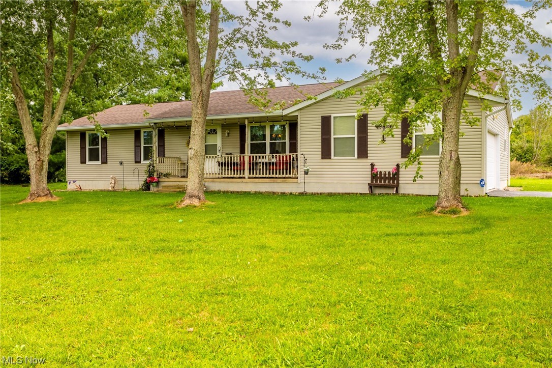 10965 Crawford Road Homerville, OH 44235 - Photo 2 of 35 Ranch-style home with garage and a front lawn
