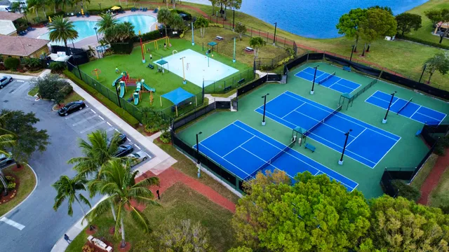 an aerial view of a house with swimming pool and outdoor seating