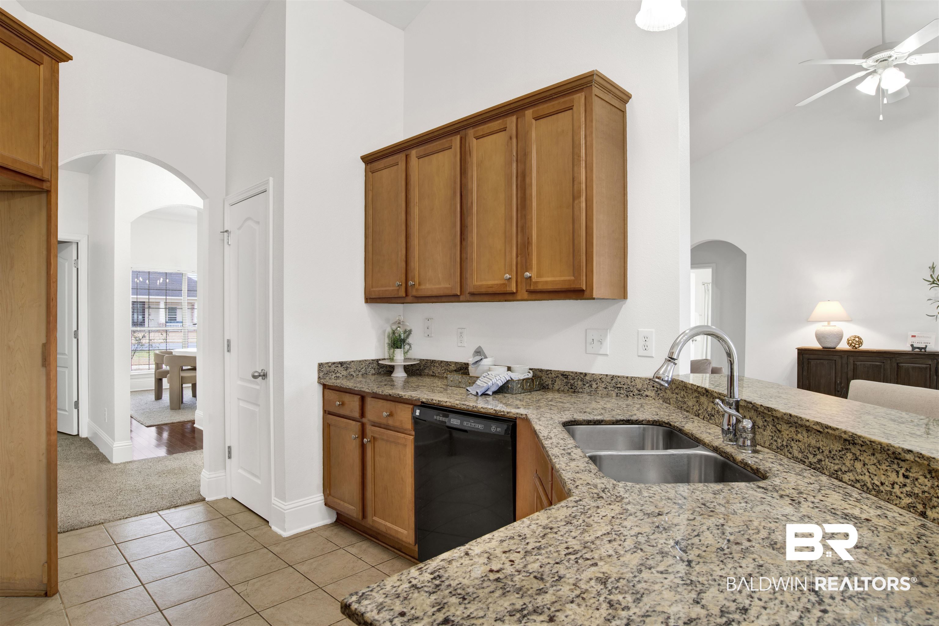 25350 Spindle Lane Daphne, AL 36526 - Photo 14 of 32 Kitchen featuring sink, high vaulted ceiling, black dishwasher, and stone counters