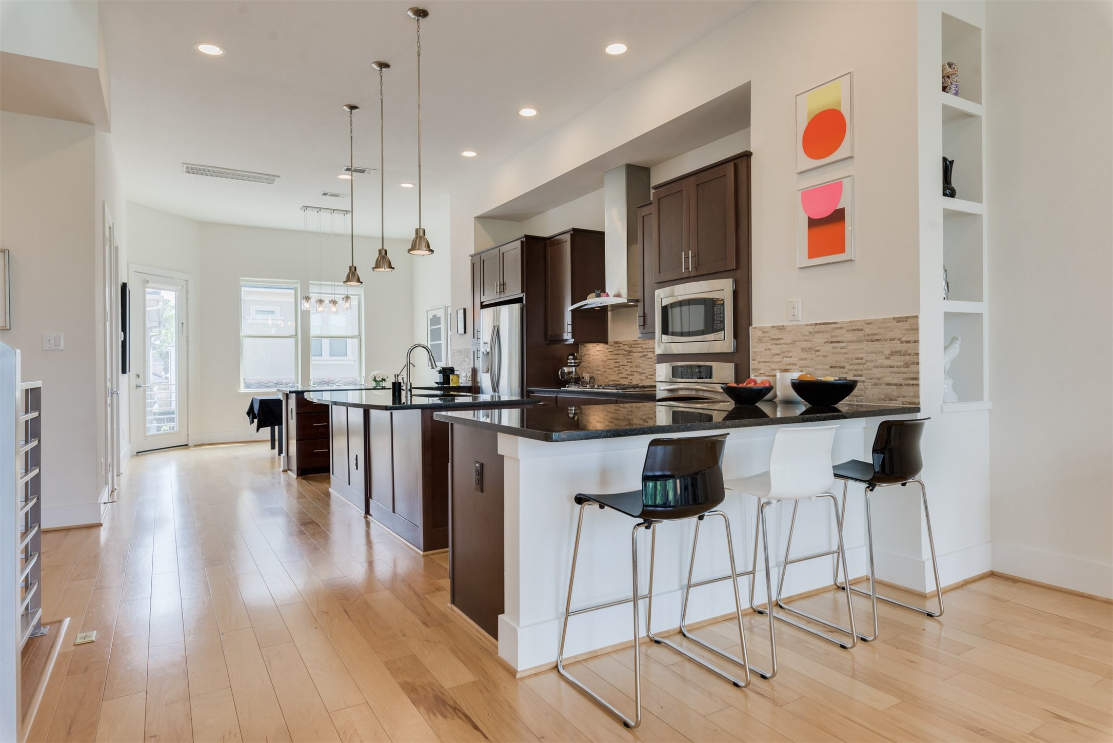 5429 Hidalgo Street, Unit B Houston, TX 77056 - Photo 13 of 38 a kitchen with stainless steel appliances kitchen island granite countertop a stove a sink and a refrigerator