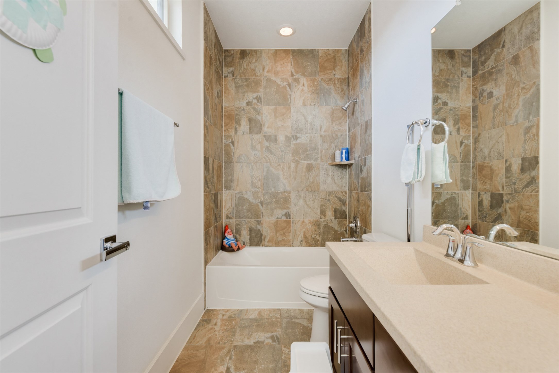 5429 Hidalgo Street, Unit B Houston, TX 77056 - Photo 30 of 38 a bathroom with a granite countertop sink a mirror and a bathtub