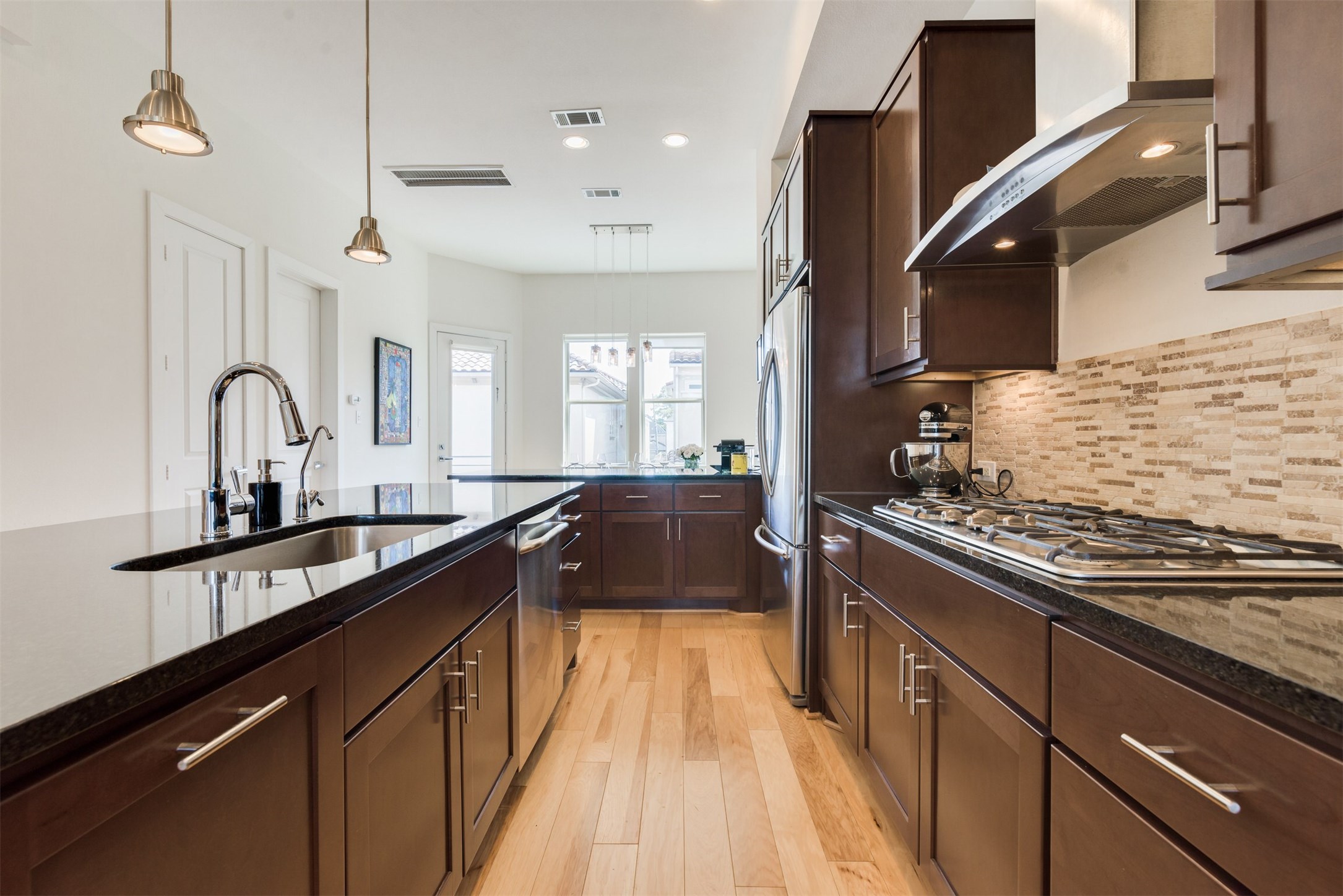 5429 Hidalgo Street, Unit B Houston, TX 77056 - Photo 9 of 38 a kitchen with kitchen island granite countertop a sink stainless steel appliances and window
