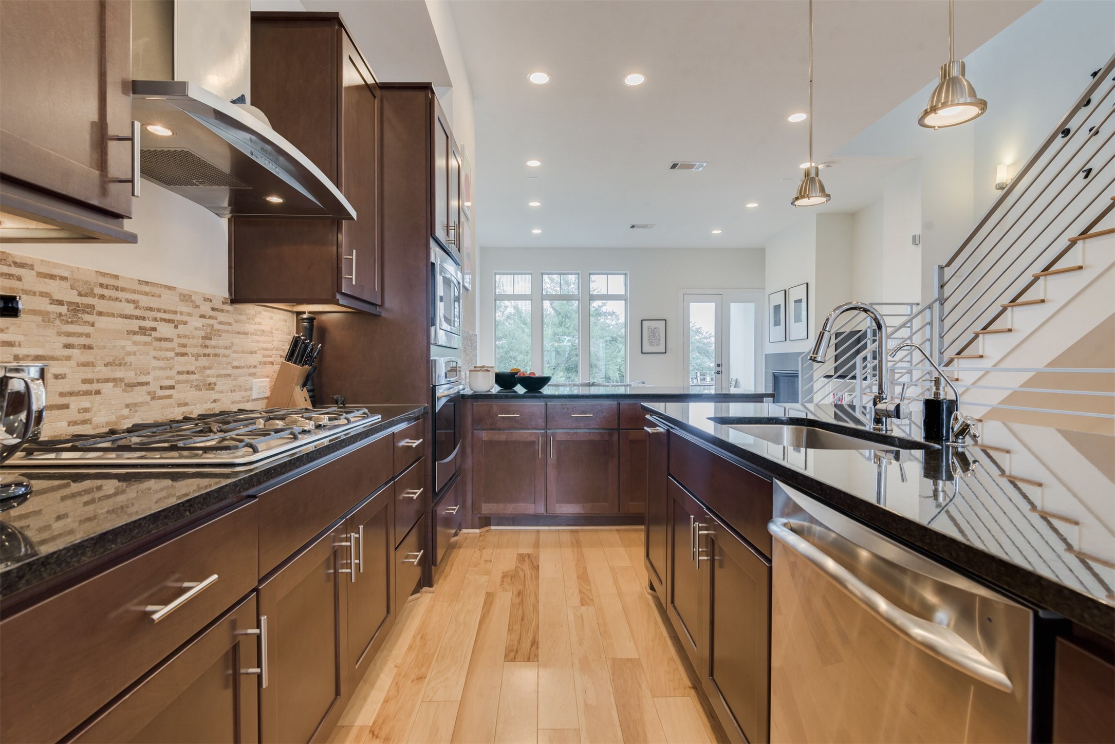 5429 Hidalgo Street, Unit B Houston, TX 77056 - Photo 10 of 38 a kitchen with kitchen island granite countertop a stove and a sink