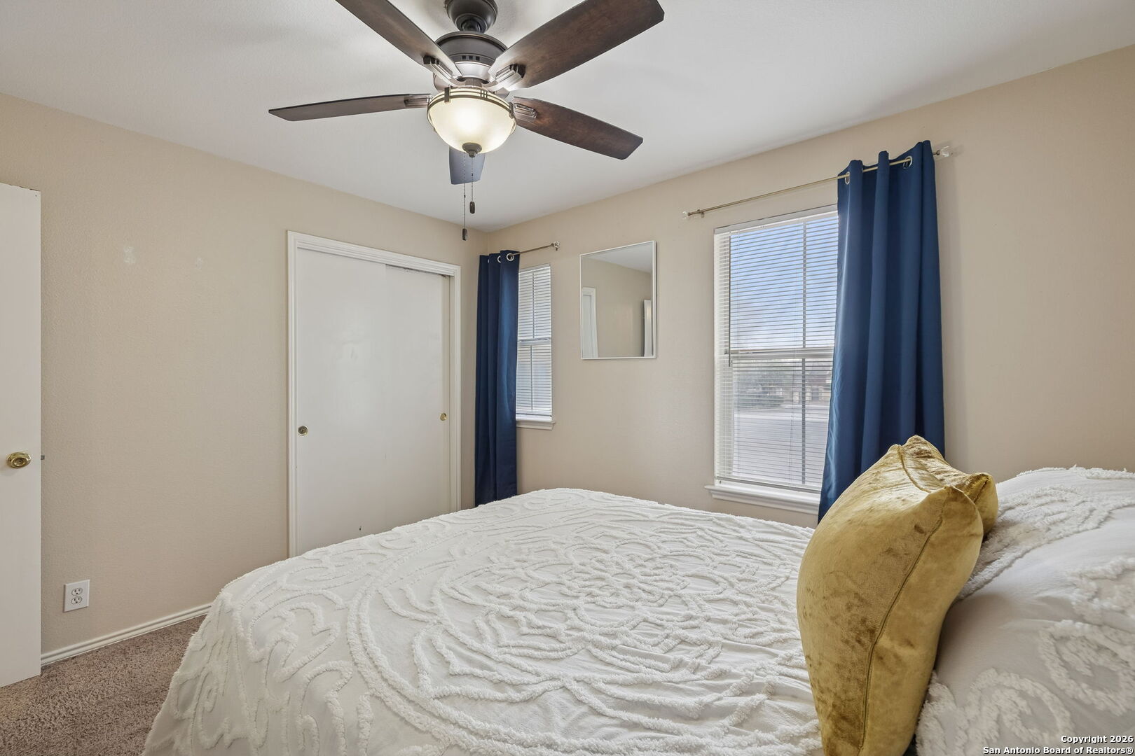 10310 Springwood Square Universal City, TX 78148 - Photo 30 of 44 a bedroom with a large bed and a chandelier