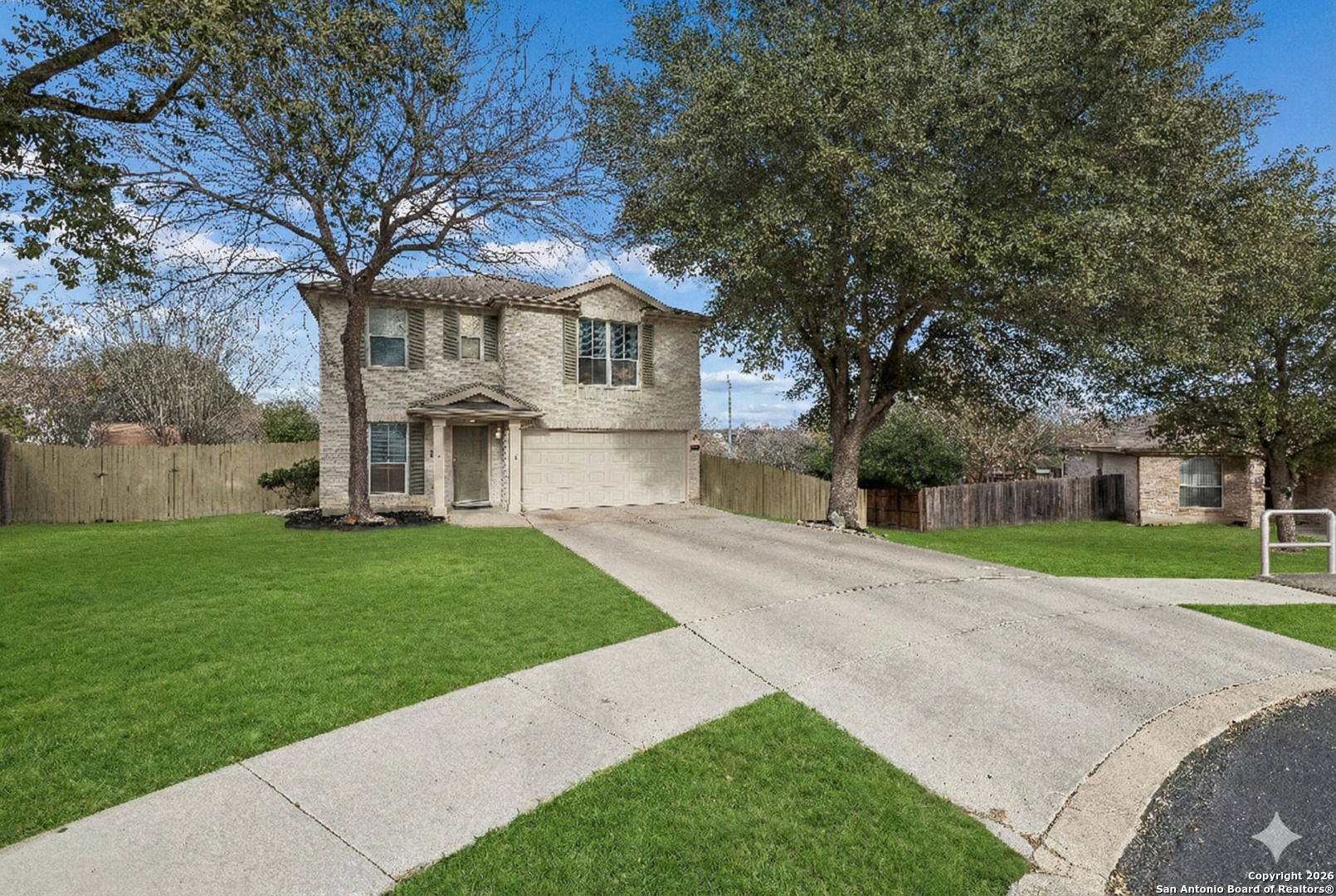 10310 Springwood Square Universal City, TX 78148 - Photo 42 of 44 a front view of a house with a yard and trees