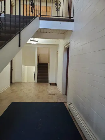 a view of entrance of the house with wooden floor