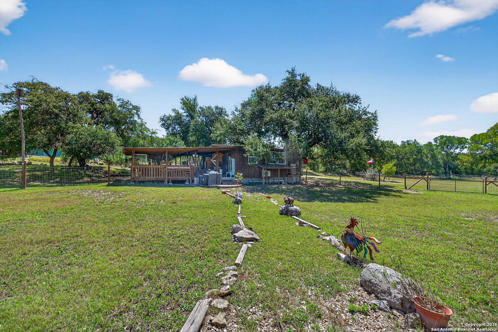 924 Wagon Creek Road Bandera, TX 78003 - Photo 19 of 33 a swimming pool with lots of green space and outdoor seating