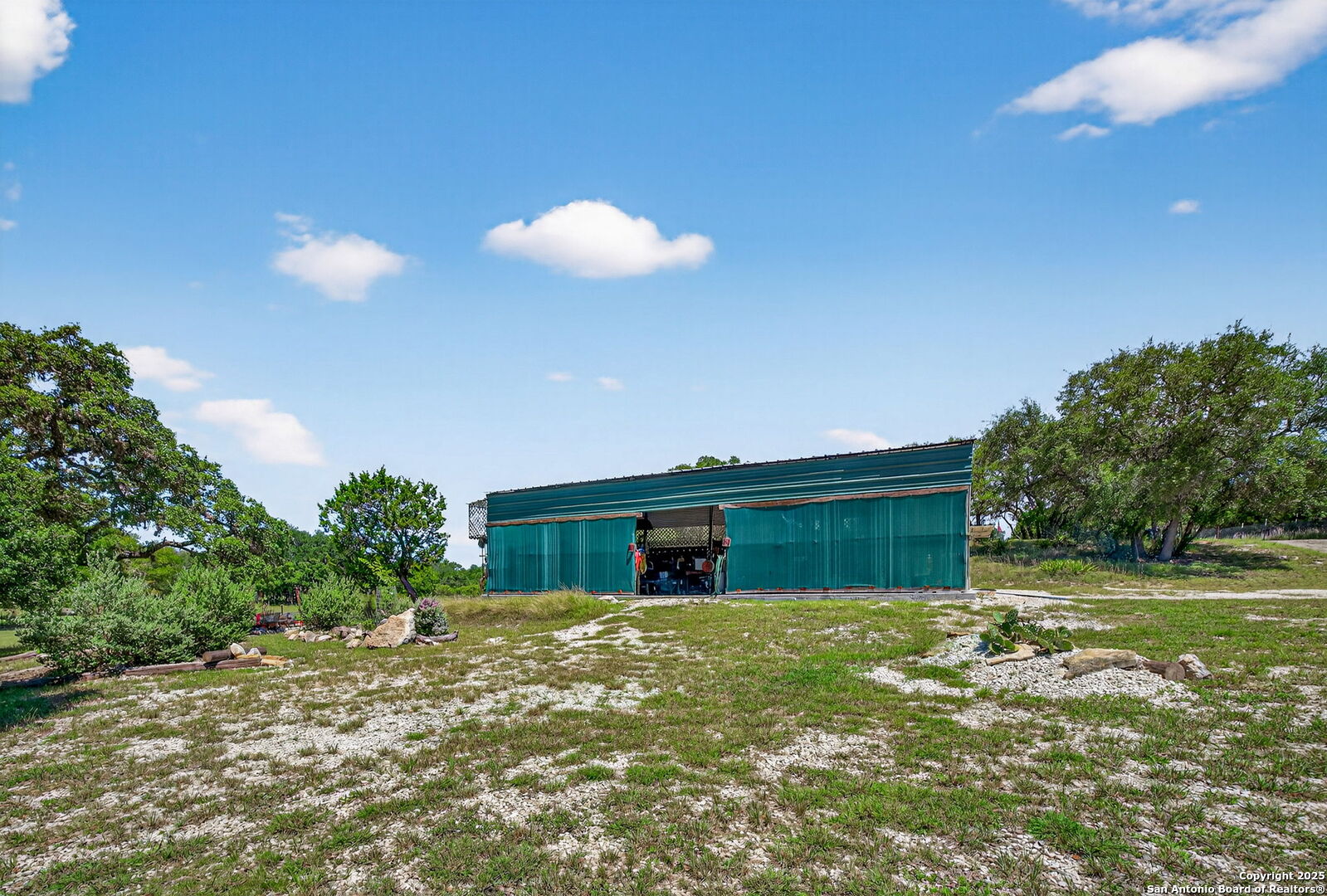924 Wagon Creek Road Bandera, TX 78003 - Photo 23 of 33 a view of a house with a backyard