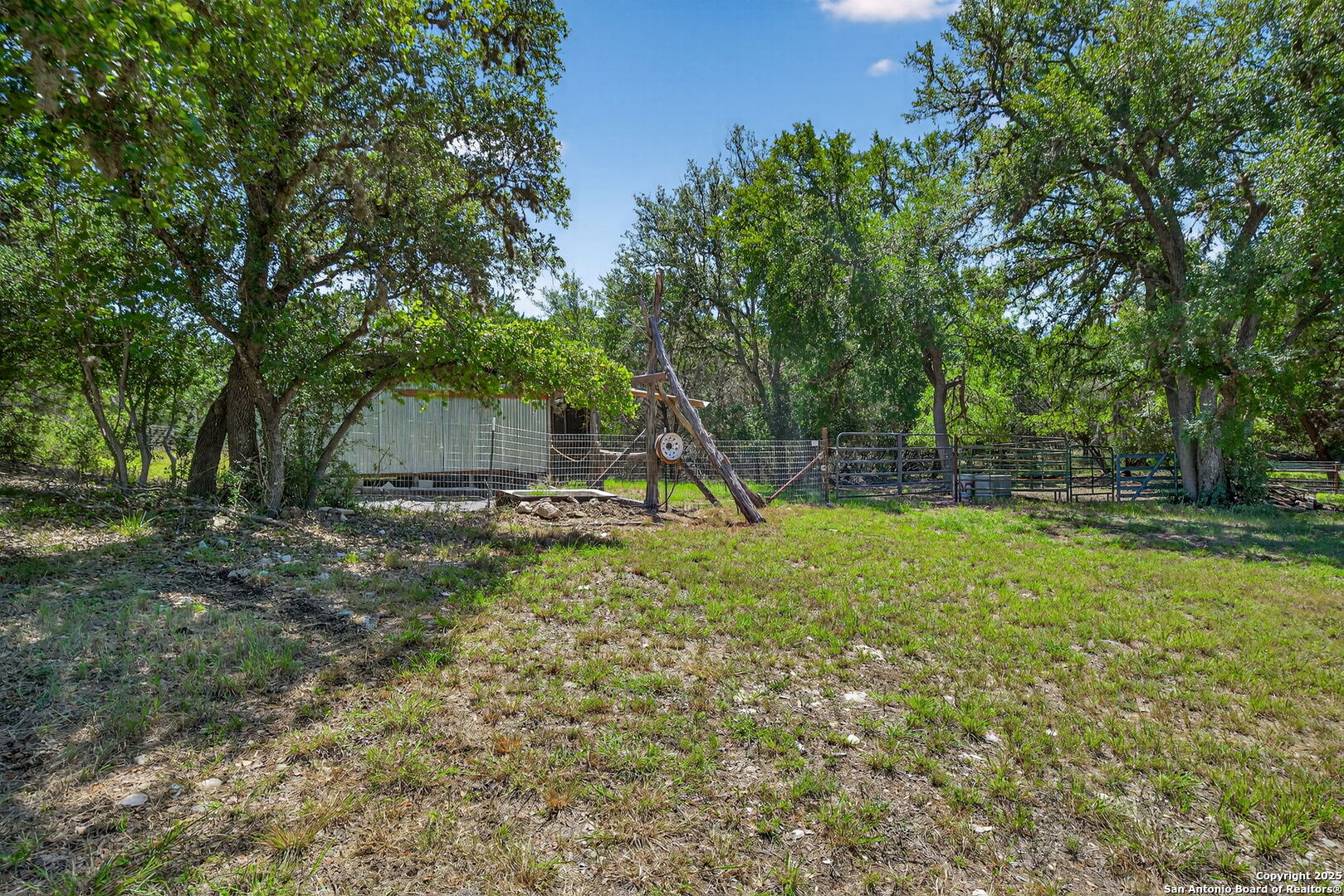 924 Wagon Creek Road Bandera, TX 78003 - Photo 24 of 33 a view of a backyard with a tree