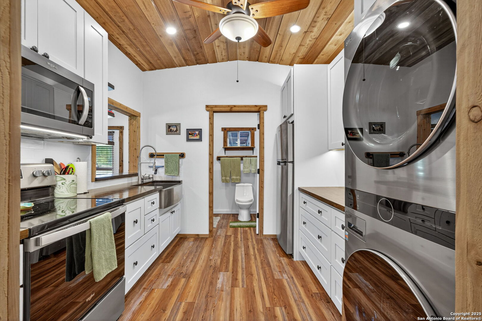 924 Wagon Creek Road Bandera, TX 78003 - Photo 9 of 33 a kitchen with stainless steel appliances a stove a chimney and a sink