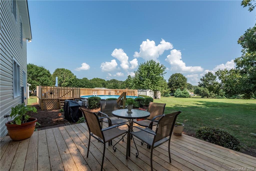 509 Baucom Deese Road, Unit 4 Monroe, NC 28110 - Photo 22 of 31 a view of a chair and tables on the roof deck