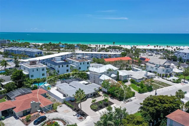 an aerial view of residential houses with outdoor space