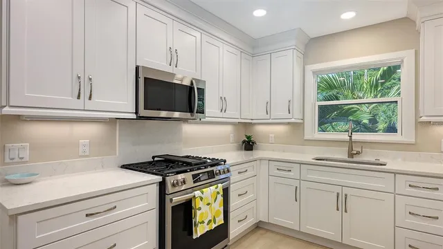 a kitchen with stainless steel appliances a refrigerator and sink