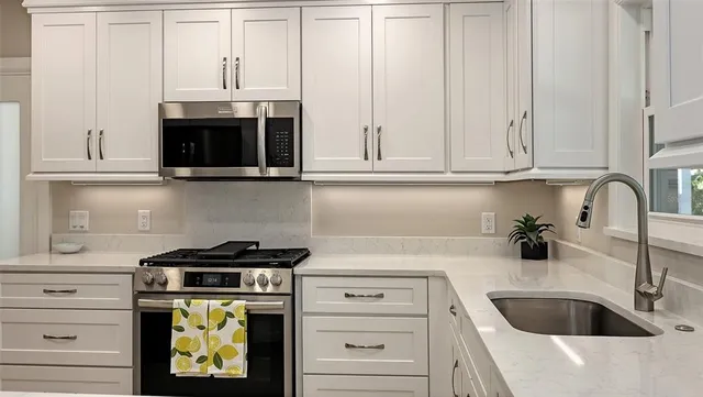 a kitchen with a sink and cabinets
