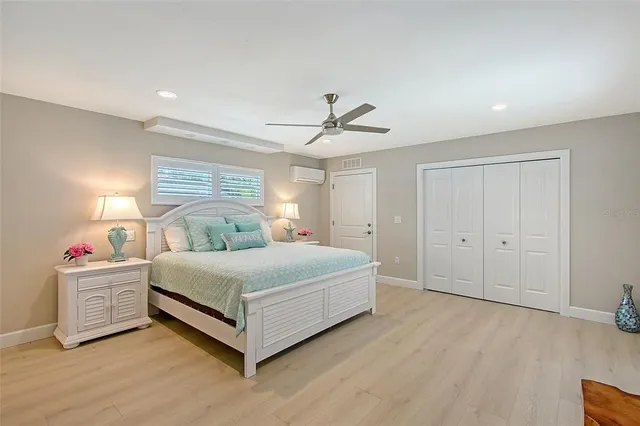 an empty room with closet and a ceiling fan