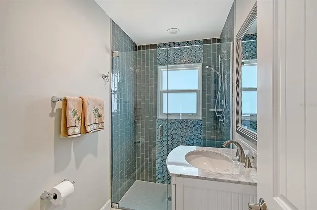 a view of a patio with table and chairs under an umbrella