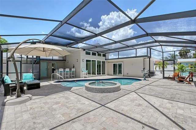 a view of a house with potted plants and palm trees