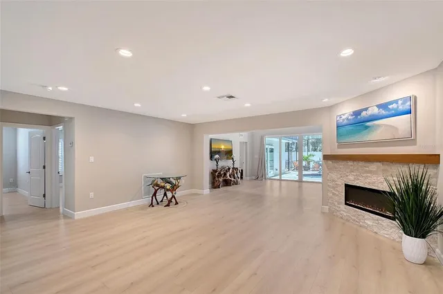 a view of a livingroom with furniture hardwood floor and a fireplace