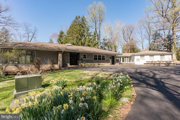 a front view of a house with a yard table and chairs