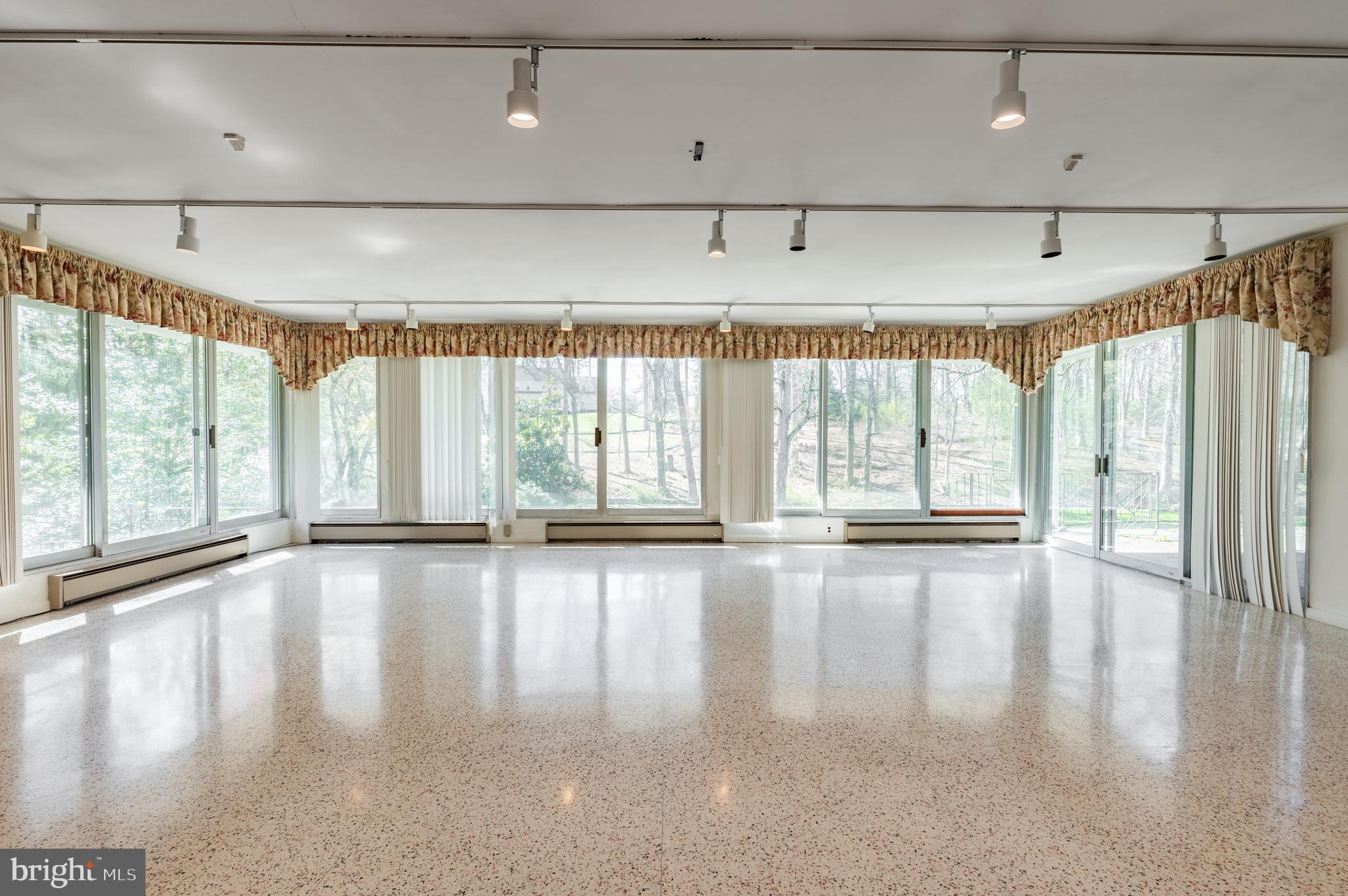 1211 East Butler Pike Ambler, PA 19002 - Photo 16 of 76 a view of an empty room with wooden floor and a window