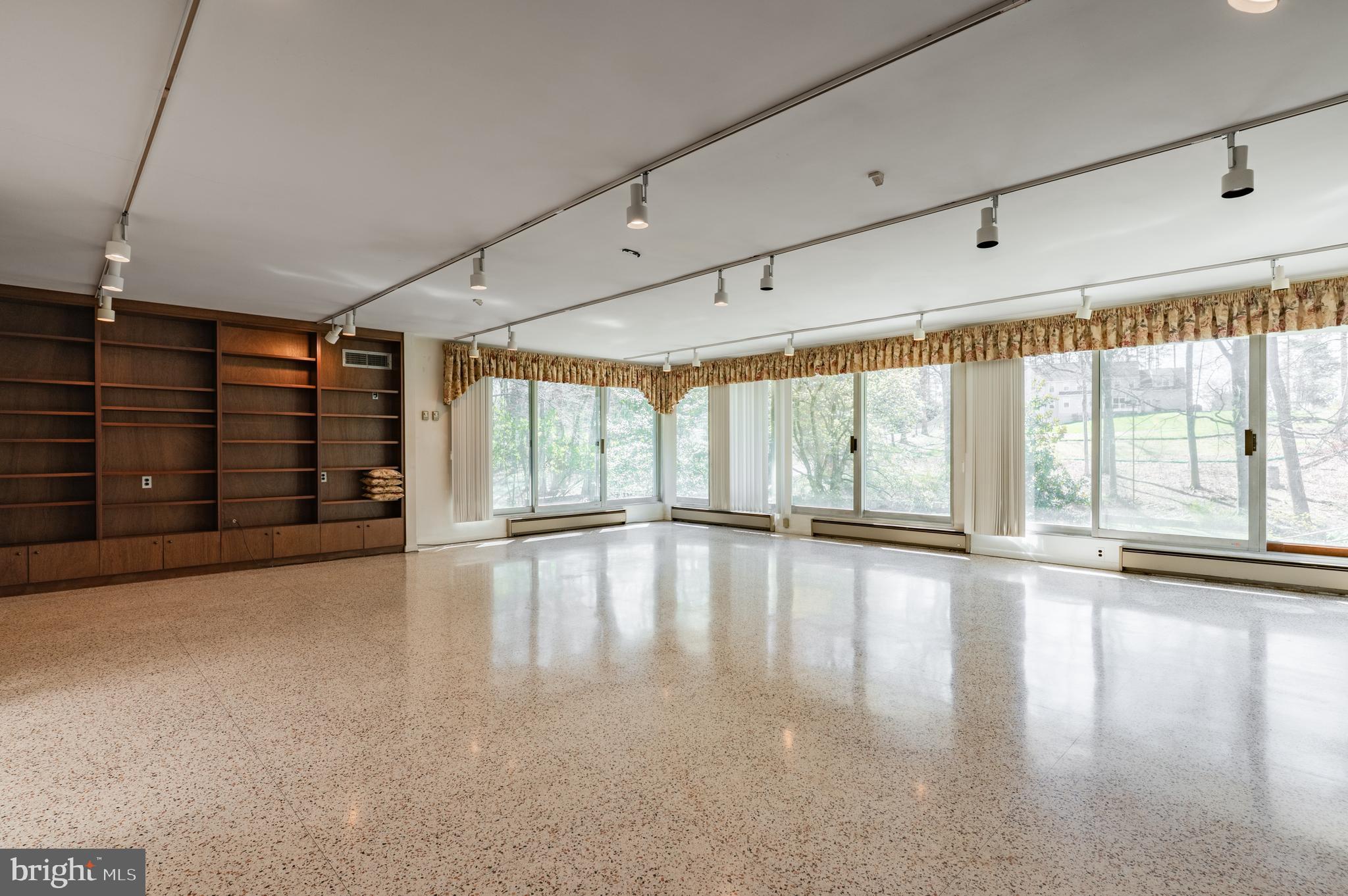 1211 East Butler Pike Ambler, PA 19002 - Photo 17 of 76 a view of an empty room with a window and wooden floor