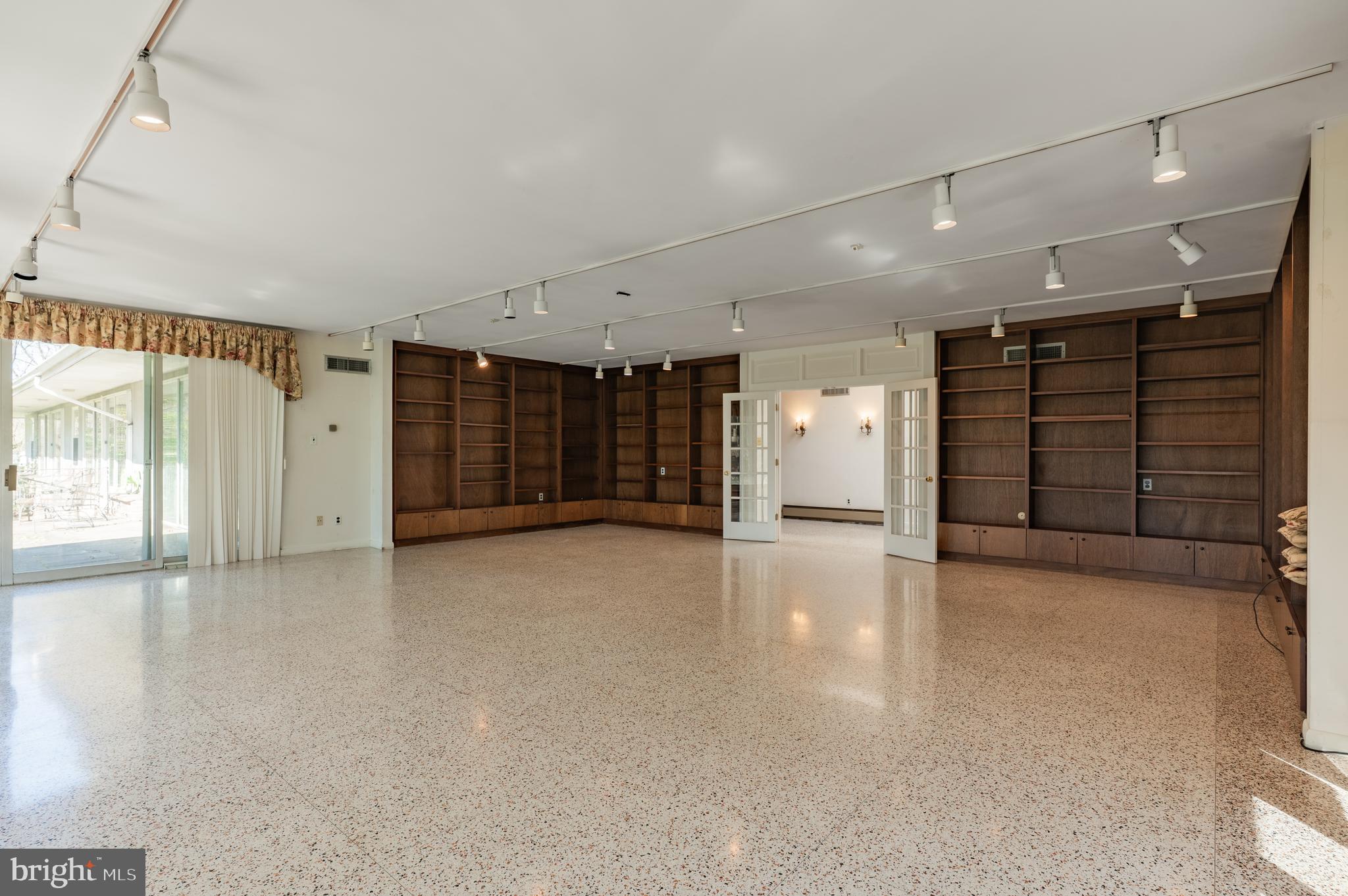 1211 East Butler Pike Ambler, PA 19002 - Photo 19 of 76 a view of an empty room with a window and a garage