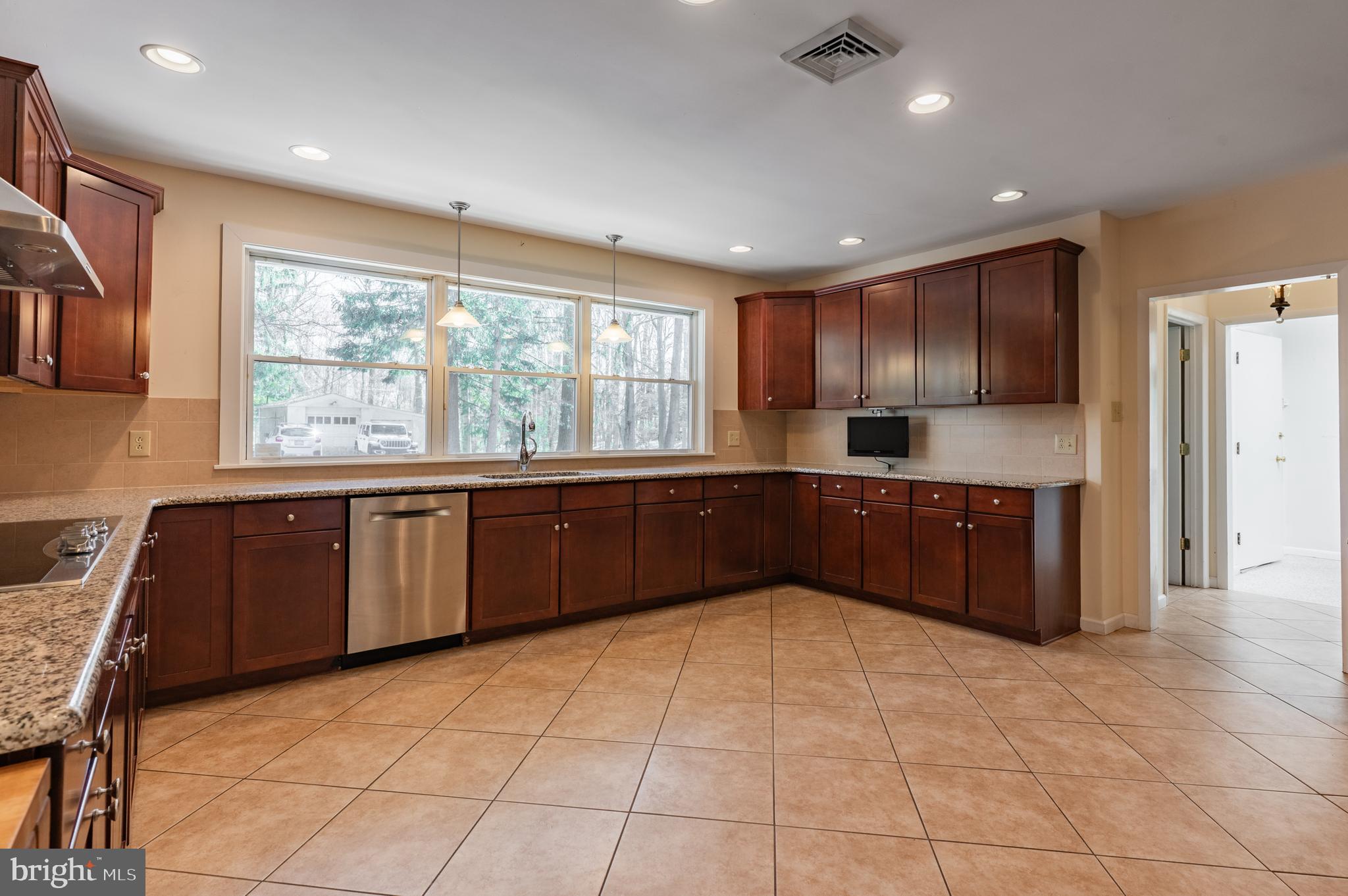 1211 East Butler Pike Ambler, PA 19002 - Photo 29 of 76 a large kitchen with kitchen island granite countertop a large counter top stainless steel appliances a sink and cabinets